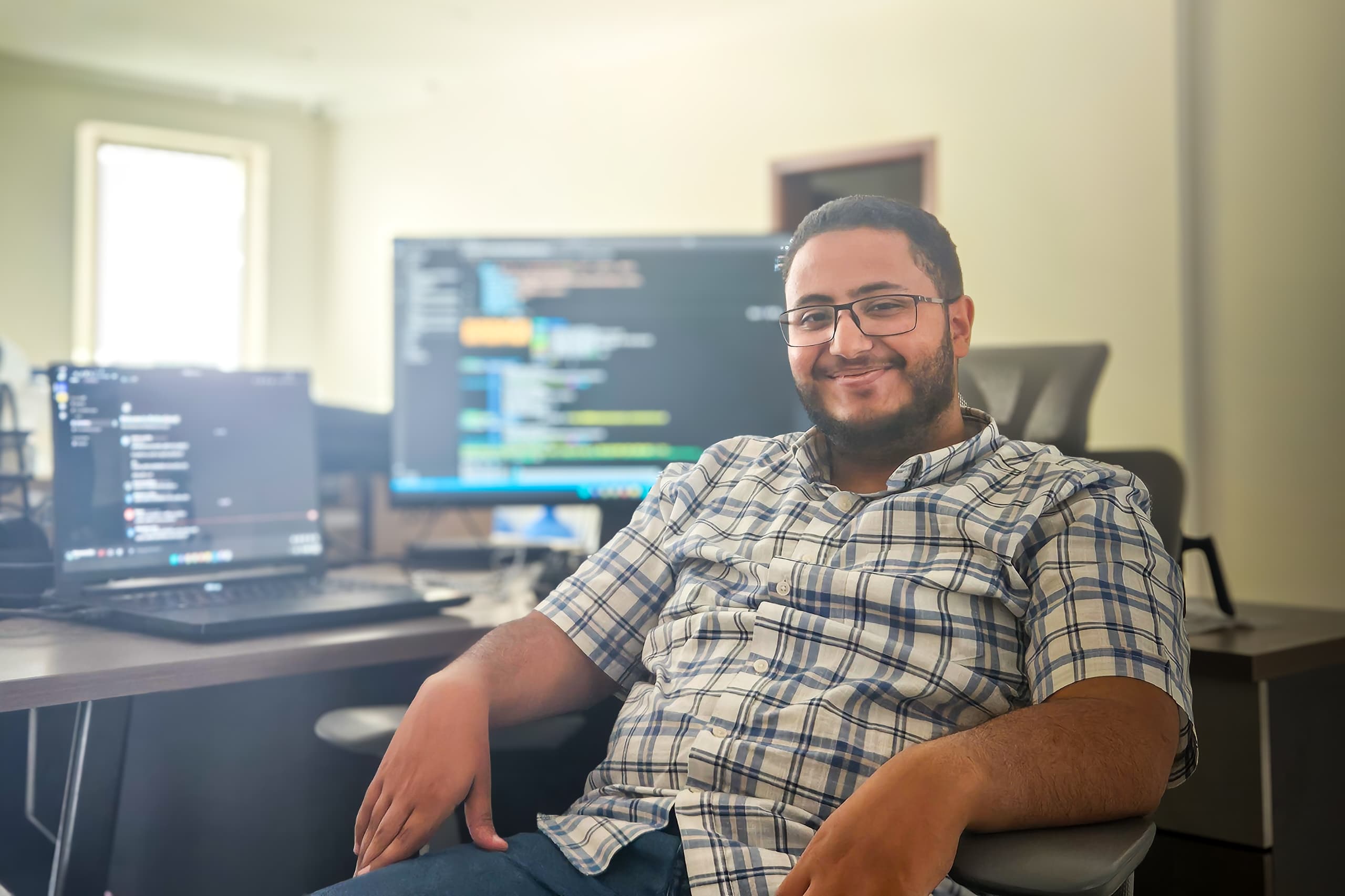 Mohammed Babaqi seated at his data engineering workstation